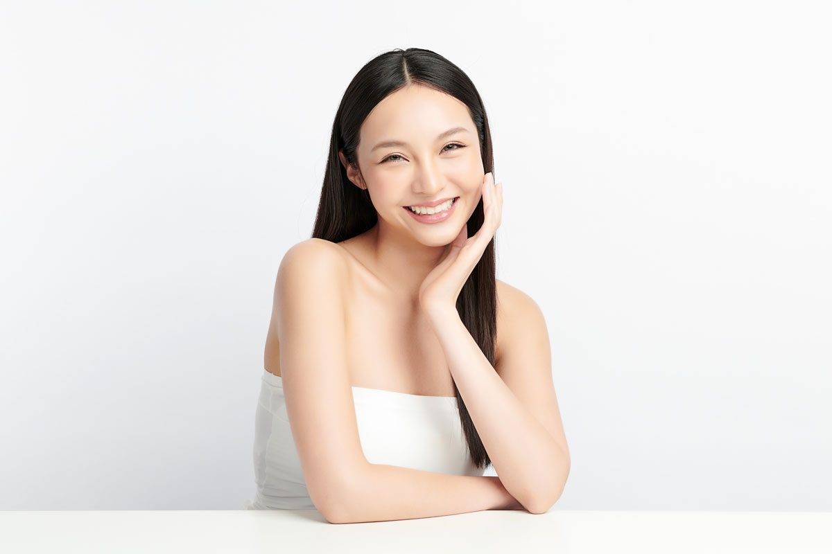 a woman smiling against a white backdrop