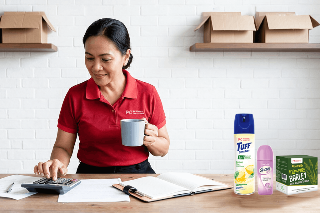 A mom holding a mug while using a calculator, with Personal Collection products displayed on top of a table.