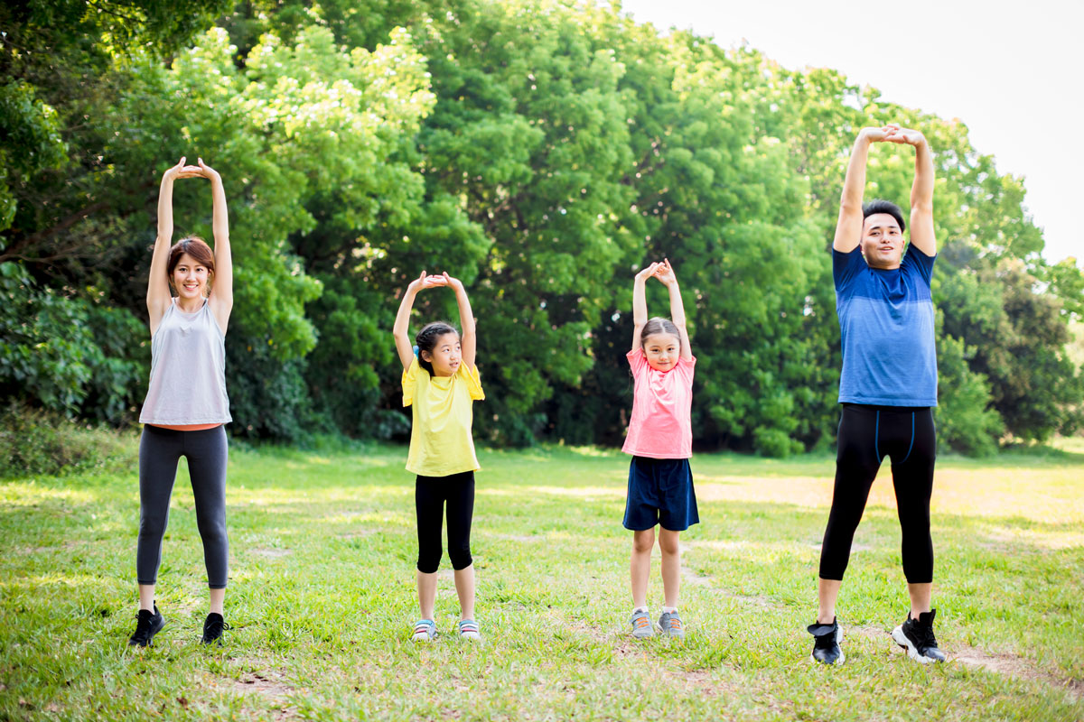 a family exercising in an open field